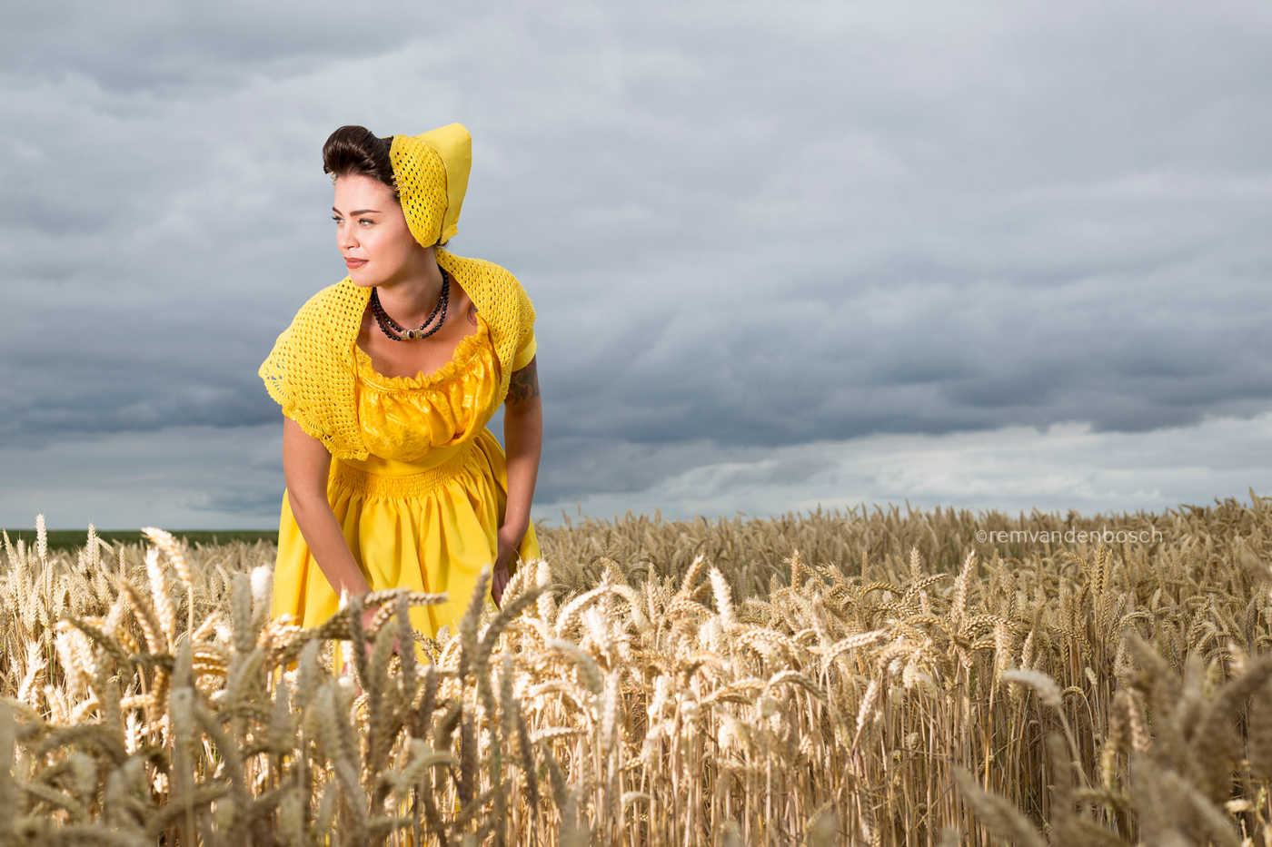 Daisy in gele Walcherse dracht in een veld vol tarwe. Gefotografeerd door Rem van Den Bosch, muurdecoratie 