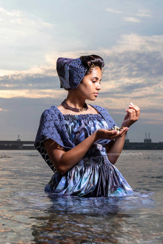 Narena in modern Walcheren costume with oyster print at the storm surge barrier