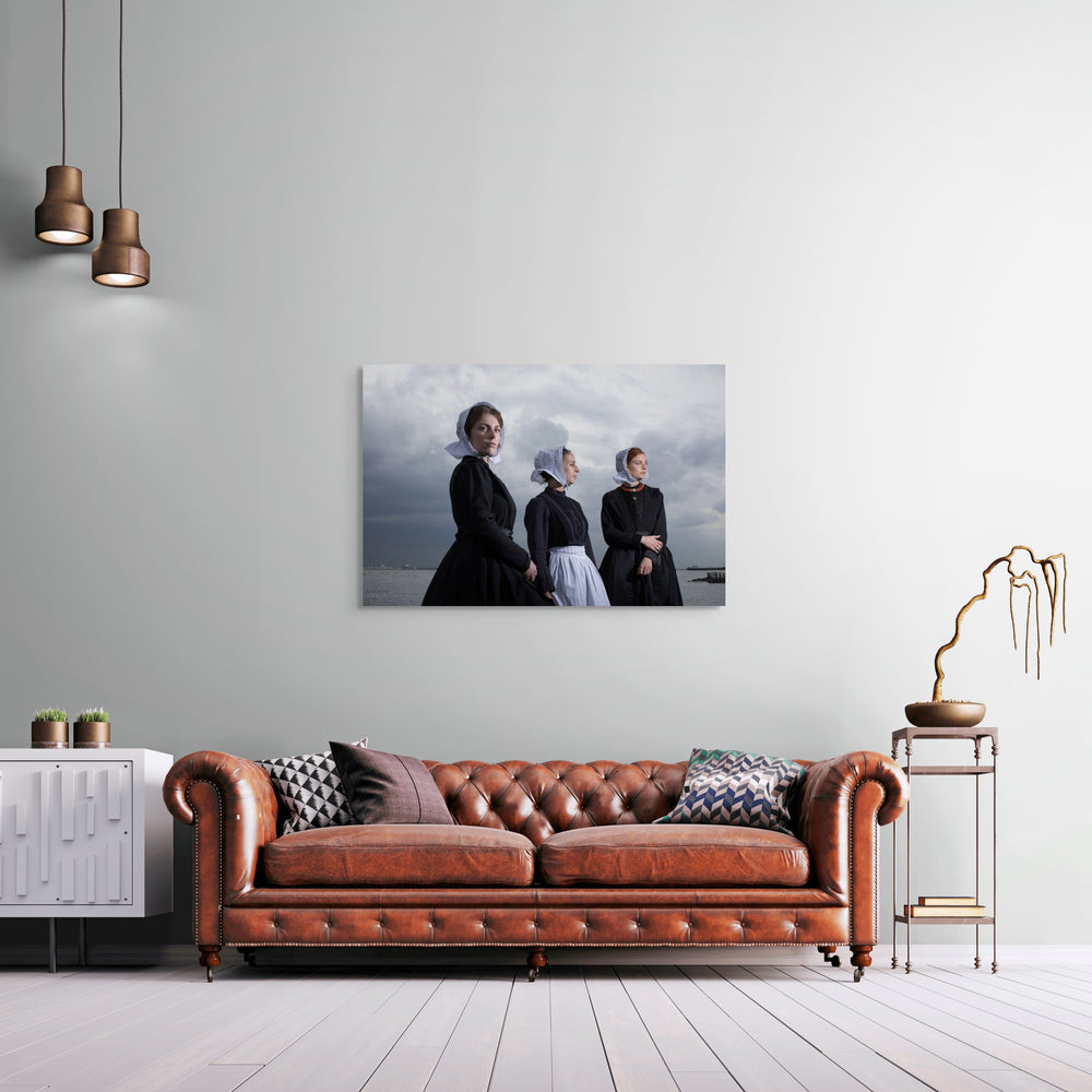 Liggend groepsportret van Charlotte, Janis en Ilyana in Cadzandse dracht aan zee, kunstfotografie door Rem van den Bosch, muurdecoratie, fotografie 